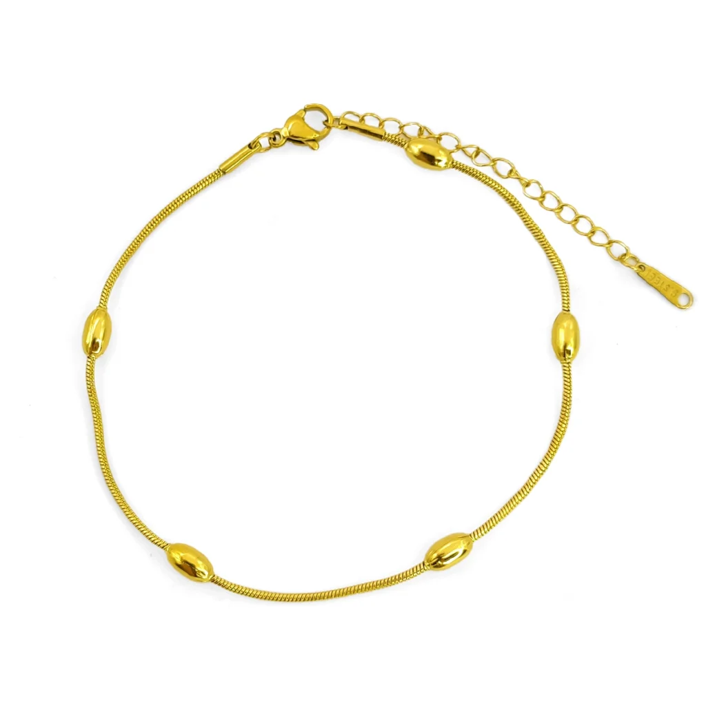 tobillera dorada tipo cola de rata con detalles de barriles en acero inoxidable sobre fondo blanco