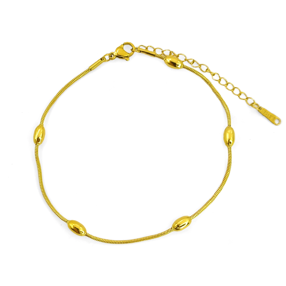 tobillera dorada tipo cola de rata con detalles de barriles en acero inoxidable sobre fondo blanco